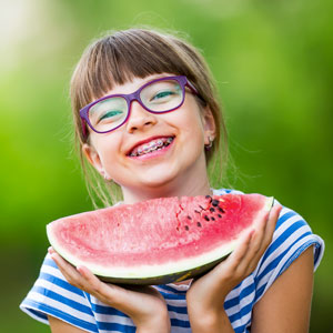 girl-with-braces-eating-watermelon-sq-300