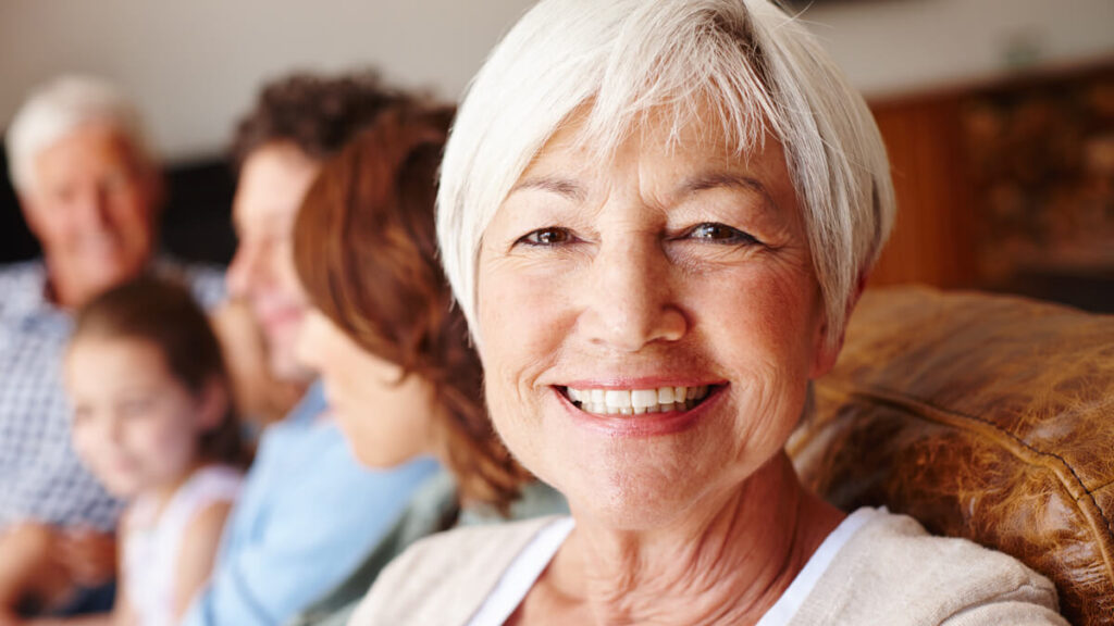 older-woman-on-couch-with-family-wide